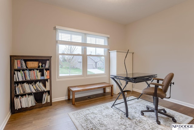 home office with wood finished floors and baseboards