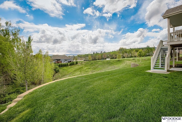 view of grassy yard with stairway