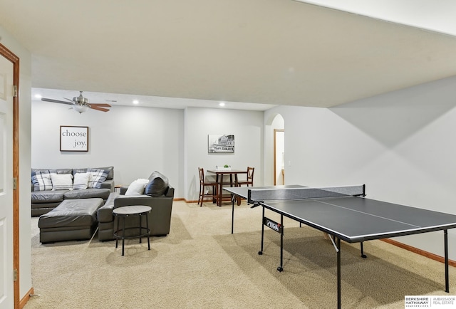recreation room with arched walkways, light colored carpet, a ceiling fan, baseboards, and recessed lighting