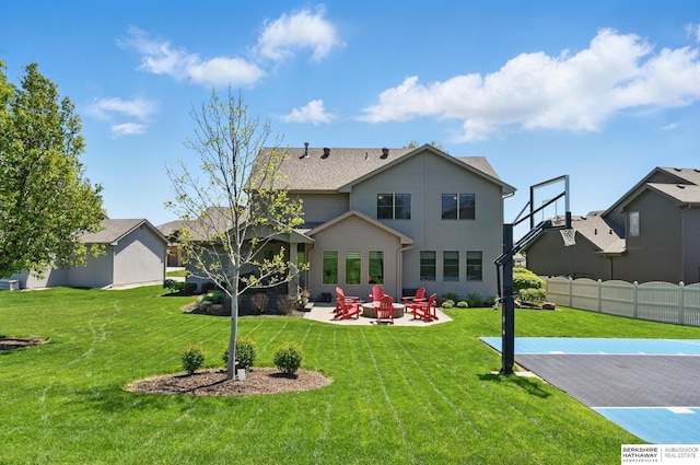 back of property with a patio area and a fire pit