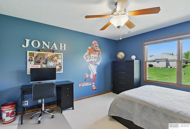 carpeted bedroom featuring an office area, baseboards, and a ceiling fan