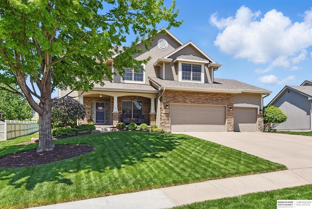 craftsman-style house featuring driveway, stone siding, an attached garage, and roof with shingles