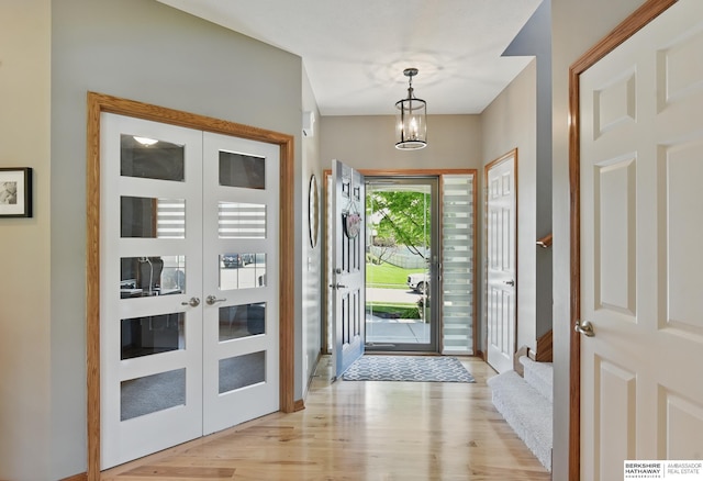 entrance foyer with light wood-style flooring and a chandelier