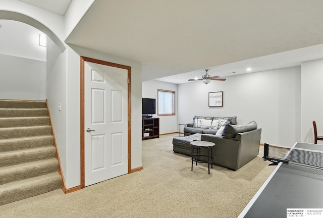 living area featuring light colored carpet, a ceiling fan, stairway, baseboards, and recessed lighting