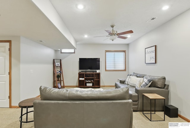 living room featuring baseboards, ceiling fan, light carpet, and recessed lighting
