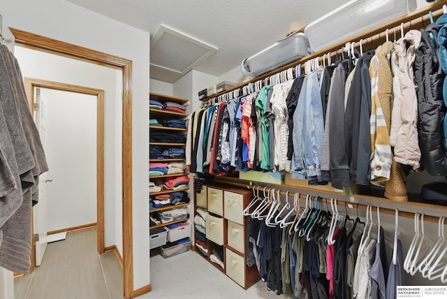 spacious closet featuring attic access