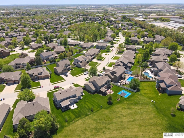 aerial perspective of suburban area featuring a pool area