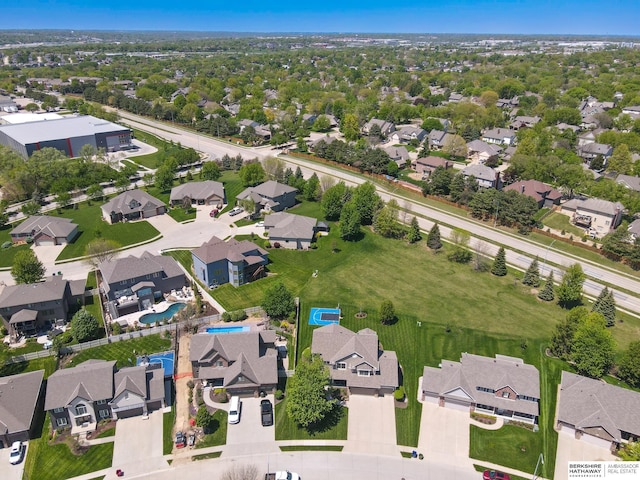 aerial view of property's location featuring nearby suburban area and a pool