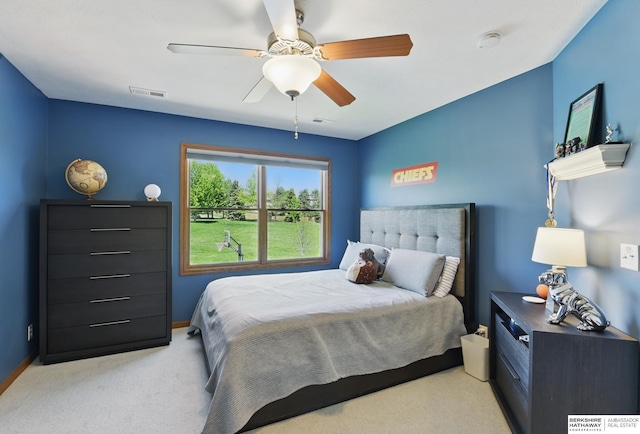 bedroom featuring light colored carpet, baseboards, and a ceiling fan