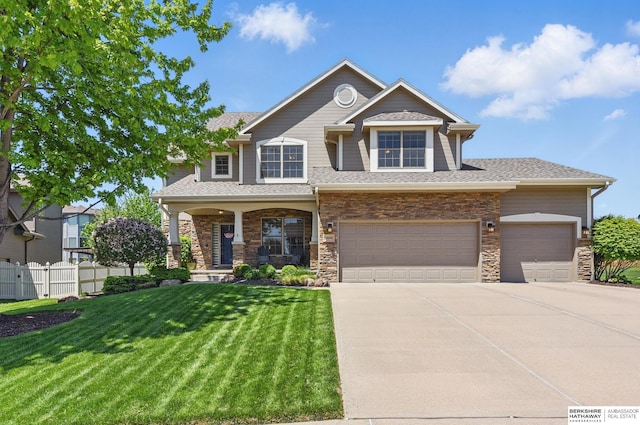 craftsman house featuring concrete driveway, a porch, a shingled roof, stone siding, and an attached garage
