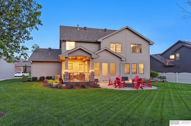 rear view of house featuring an outdoor fire pit, a patio area, and a shingled roof
