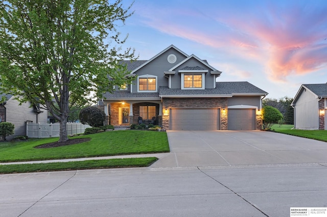 craftsman house featuring driveway, stone siding, and an attached garage