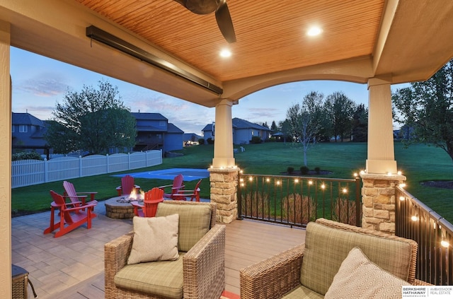 view of patio featuring an outdoor fire pit and a ceiling fan