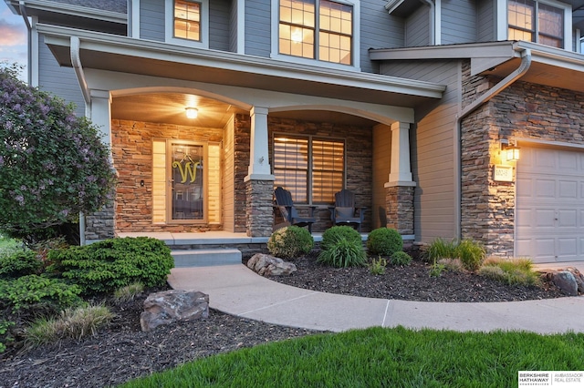 entrance to property featuring stone siding and covered porch