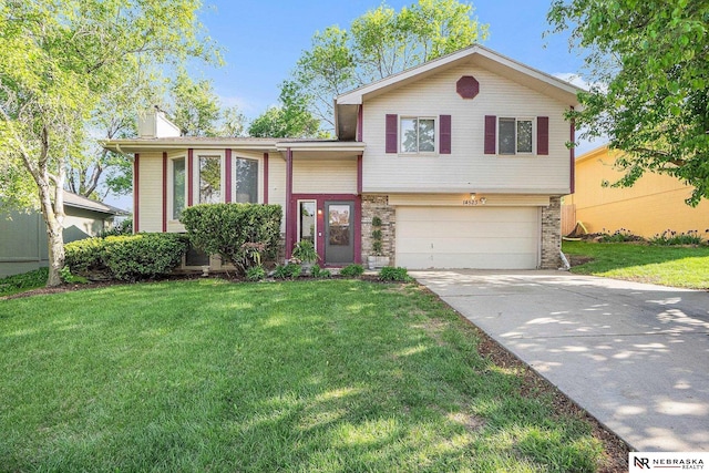 14523 Parker St, Omaha, NE 68154 - split level home featuring a garage, driveway, brick siding, a front yard, and a chimney