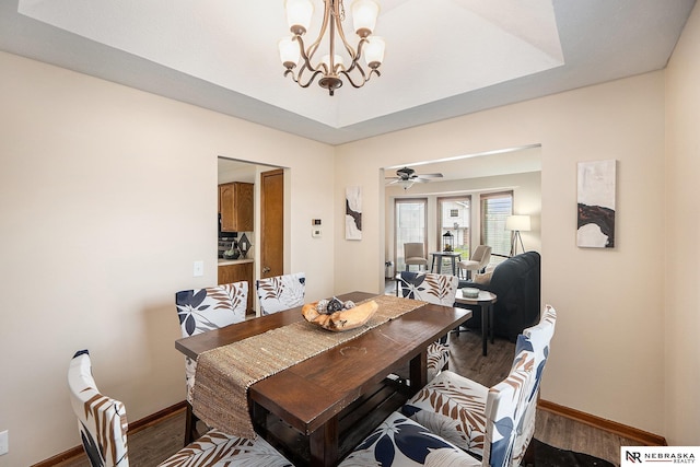 14523 Parker St, Omaha, NE 68154 - dining area featuring a chandelier, wood finished floors, and baseboards