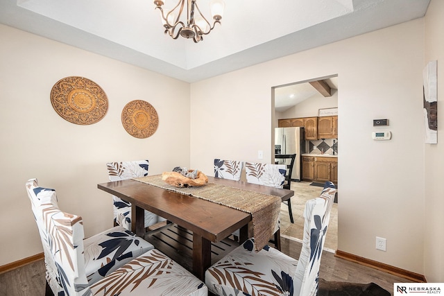 14523 Parker St, Omaha, NE 68154 - dining area featuring a chandelier, light wood-style floors, and baseboards