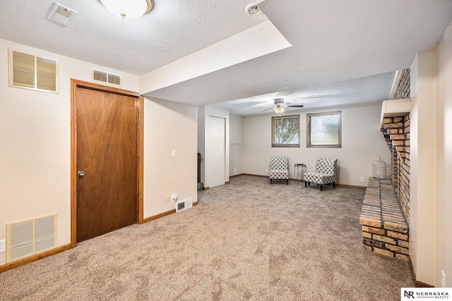 14523 Parker St, Omaha, NE 68154 - below grade area with carpet flooring, ceiling fan, baseboards, a brick fireplace, and a textured ceiling