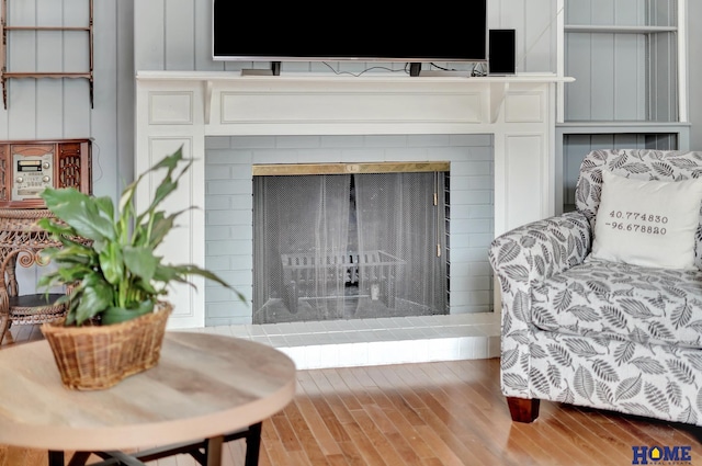detailed view of a fireplace with raised hearth and wood finished floors