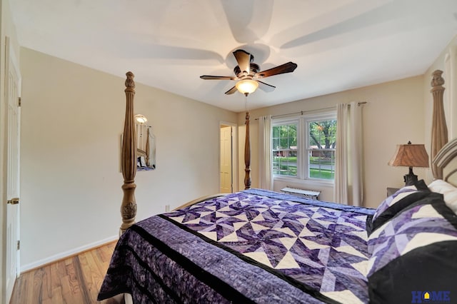bedroom with light wood-style flooring, a ceiling fan, and baseboards