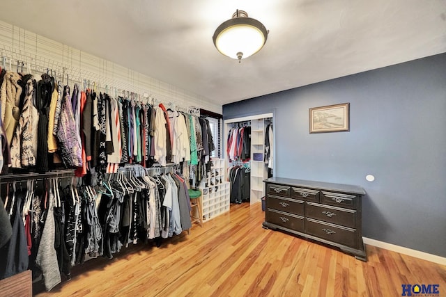 walk in closet featuring light wood-style flooring