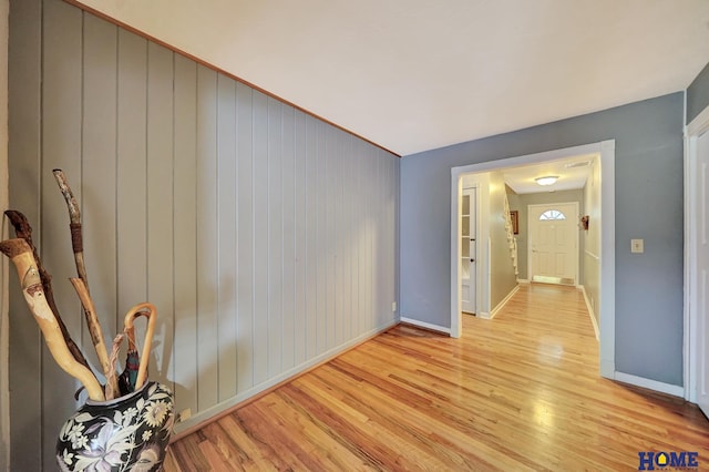 spare room featuring light wood finished floors and baseboards