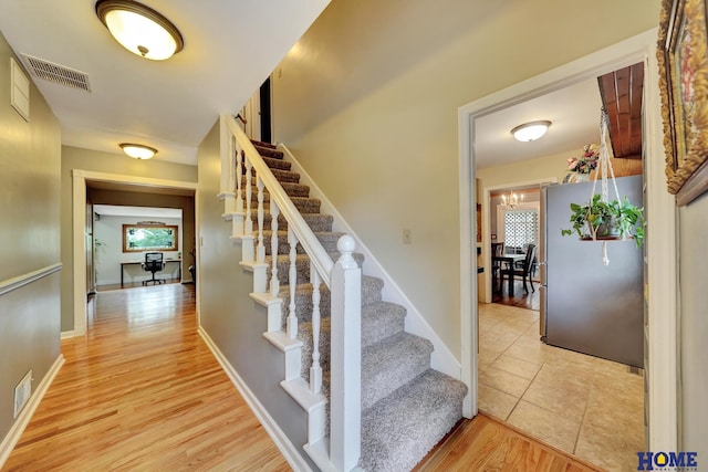 stairs featuring wood finished floors