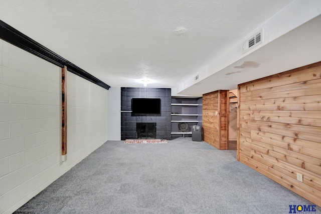 unfurnished living room with carpet floors and a fireplace