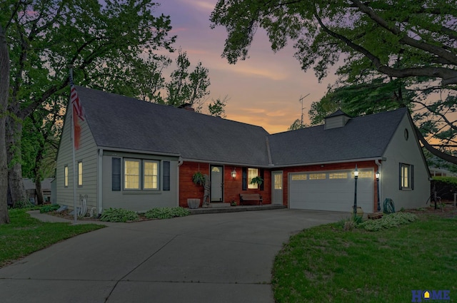 view of front facade with a garage, driveway, and a front lawn
