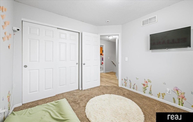 11019 Weber St, Omaha, NE 68142 - rec room featuring carpet floors, a textured ceiling, and baseboards