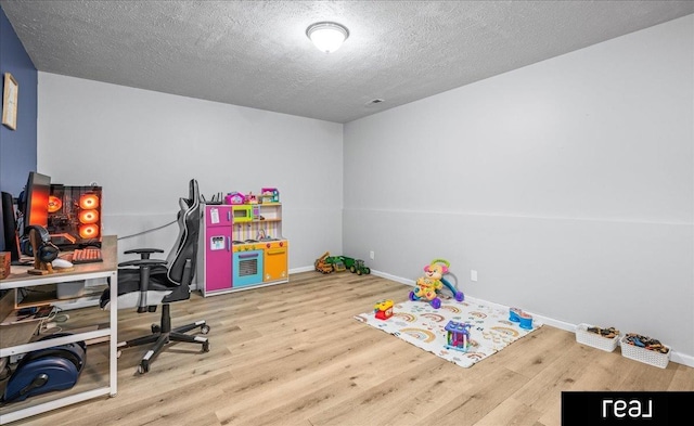 11019 Weber St, Omaha, NE 68142 - rec room featuring wood finished floors, baseboards, a textured ceiling, and a desk