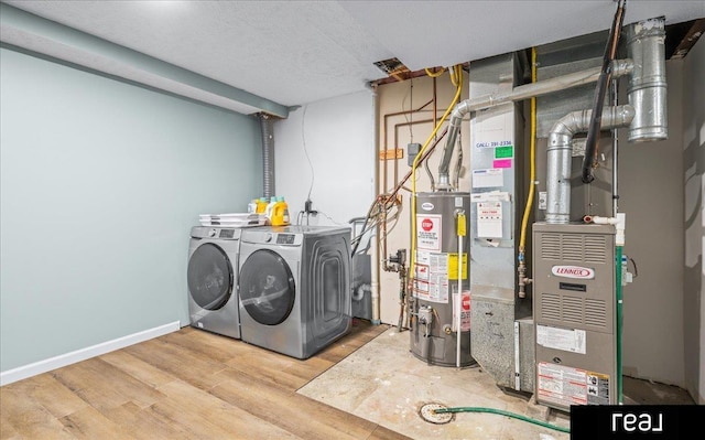 11019 Weber St, Omaha, NE 68142 - laundry room with washer and dryer, gas water heater, and wood finished floors