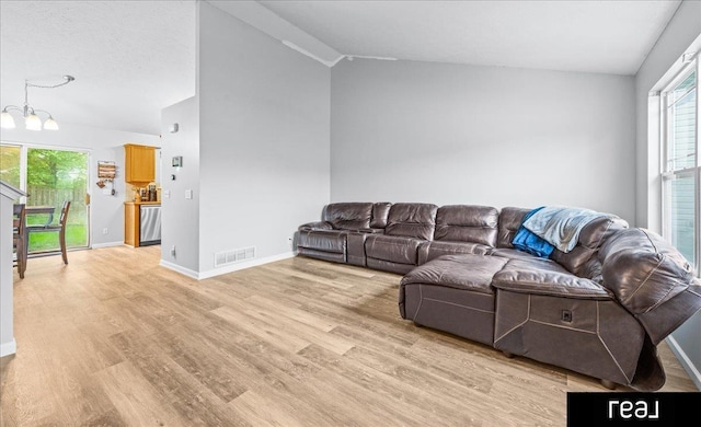 11019 Weber St, Omaha, NE 68142 - living room featuring vaulted ceiling, light wood finished floors, healthy amount of natural light, and baseboards