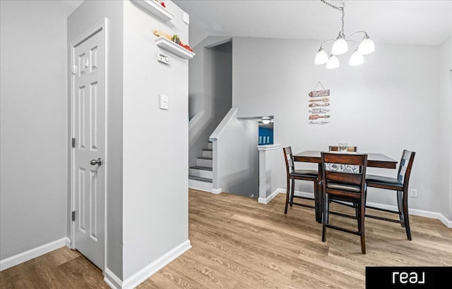 11019 Weber St, Omaha, NE 68142 - dining space with a chandelier, wood finished floors, baseboards, and stairs