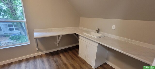1321 N Main St, Henderson, NE 68371 - unfurnished office with a sink, dark wood-type flooring, vaulted ceiling, and baseboards