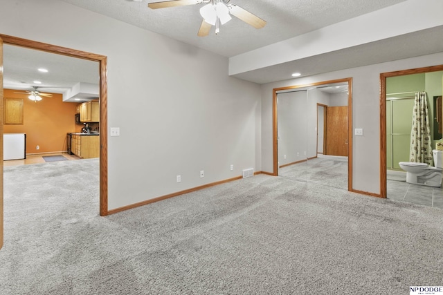 unfurnished room with a ceiling fan, light carpet, baseboards, a textured ceiling, and recessed lighting