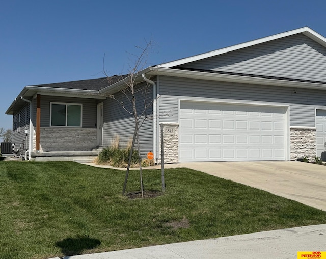3545 Little Bluestem Rd, Fremont, NE 68025 - view of front of home featuring stone siding, a garage, and concrete driveway
