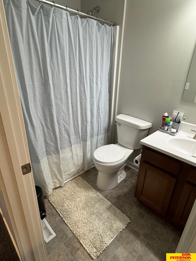 3545 Little Bluestem Rd, Fremont, NE 68025 - bathroom featuring toilet, vanity, and curtained shower