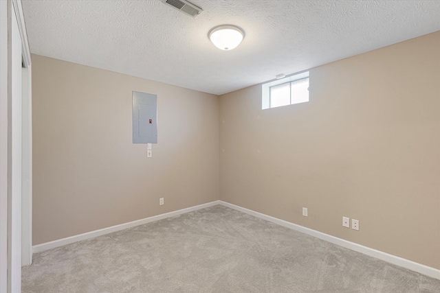 below grade area featuring electric panel, light colored carpet, baseboards, and a textured ceiling