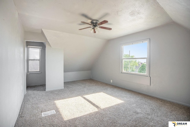 bonus room featuring vaulted ceiling, carpet floors, ceiling fan, and baseboards