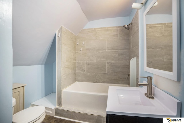 bathroom featuring a shower, vaulted ceiling, toilet, and vanity