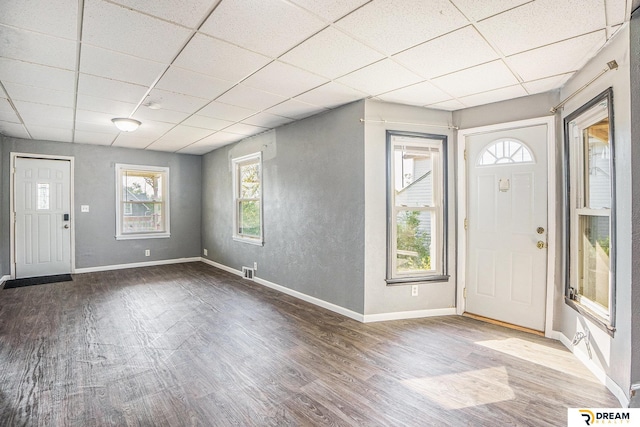 foyer entrance with a paneled ceiling, wood finished floors, and baseboards