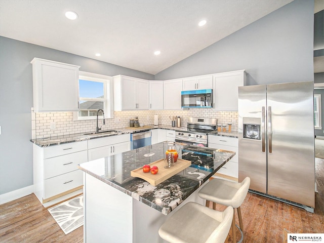5910 SW 9th St, Lincoln, NE 68523 - kitchen with appliances with stainless steel finishes, a sink, stone countertops, backsplash, and white cabinetry