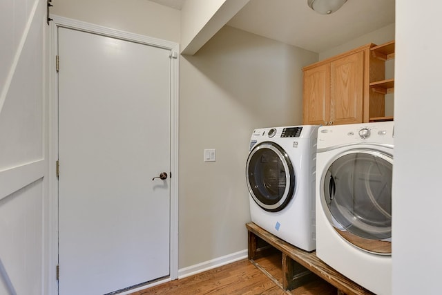 8114 S 167th St, Omaha, NE 68136 - laundry room with independent washer and dryer, cabinet space, and light wood-style floors