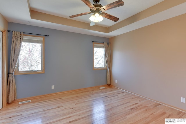 8114 S 167th St, Omaha, NE 68136 - unfurnished room featuring a raised ceiling, light wood-type flooring, and a ceiling fan