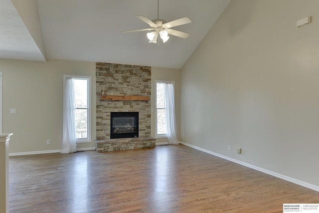 8114 S 167th St, Omaha, NE 68136 - unfurnished living room with a ceiling fan, high vaulted ceiling, wood finished floors, and a stone fireplace