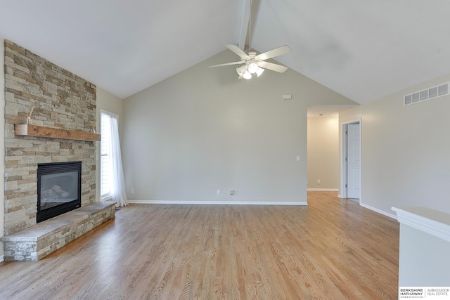 8114 S 167th St, Omaha, NE 68136 - unfurnished living room featuring high vaulted ceiling, ceiling fan, a stone fireplace, light wood-type flooring, and beamed ceiling