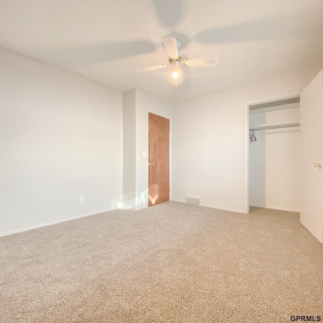 101 E 28th Ave, Bellevue, NE 68005 - unfurnished bedroom with carpet flooring, a closet, baseboards, and a ceiling fan