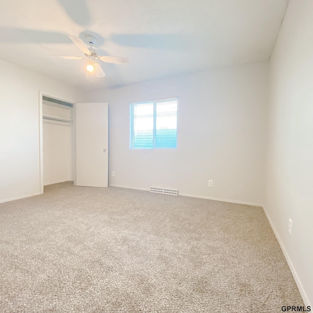 101 E 28th Ave, Bellevue, NE 68005 - unfurnished bedroom featuring light colored carpet, a closet, a ceiling fan, and baseboards