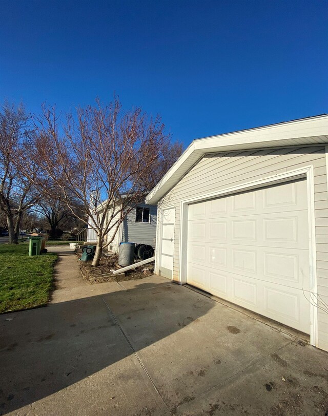 101 E 28th Ave, Bellevue, NE 68005 - view of side of home featuring a garage, an outbuilding, and driveway